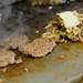 Burger patties grill on a flattop during lunch hour at Blimpy Burger in downtown Ann Arbor. Melanie Maxwell | AnnArbor.com